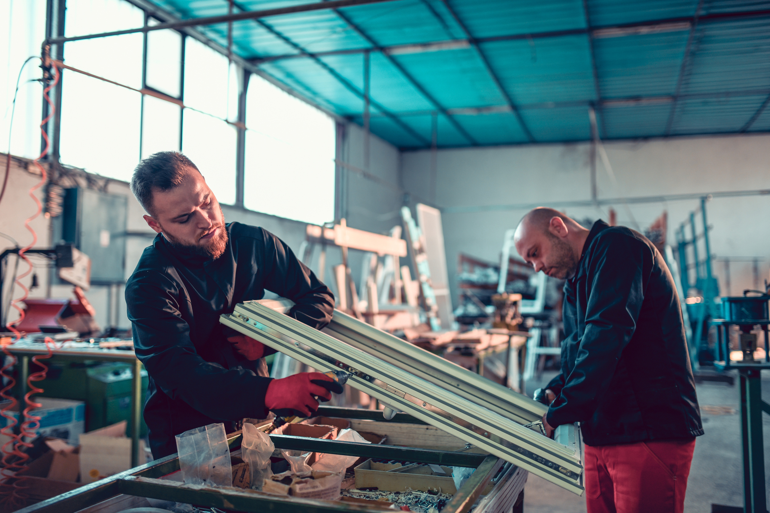 Workers Making Window Frame Out Of Aluminum